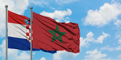 Croatia and Morocco flag waving in the wind against white cloudy blue sky together. Diplomacy concept, international relations.
