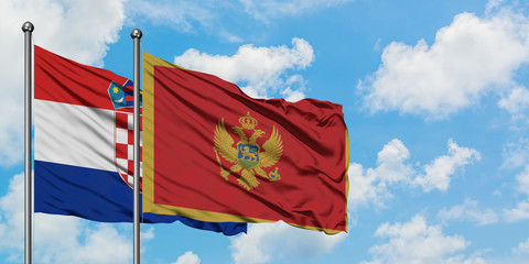 Croatia and Montenegro flag waving in the wind against white cloudy blue sky together. Diplomacy concept, international relations.