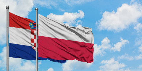 Croatia and Poland flag waving in the wind against white cloudy blue sky together. Diplomacy concept, international relations.