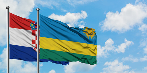 Croatia and Rwanda flag waving in the wind against white cloudy blue sky together. Diplomacy concept, international relations.