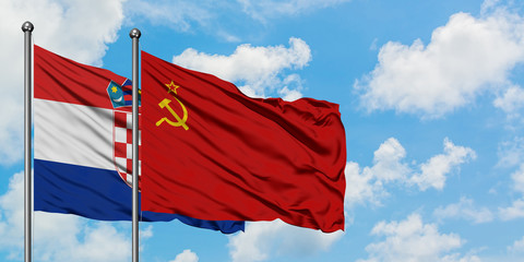 Croatia and Soviet Union flag waving in the wind against white cloudy blue sky together. Diplomacy concept, international relations.