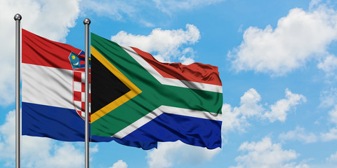 Croatia and South Africa flag waving in the wind against white cloudy blue sky together. Diplomacy concept, international relations.