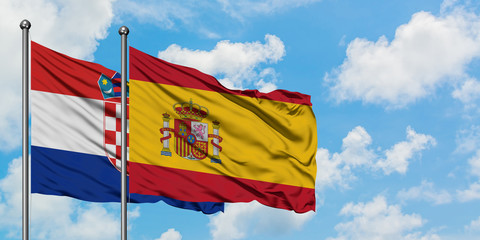 Croatia and Spain flag waving in the wind against white cloudy blue sky together. Diplomacy concept, international relations.
