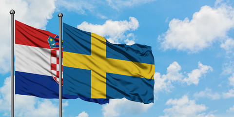 Croatia and Sweden flag waving in the wind against white cloudy blue sky together. Diplomacy concept, international relations.