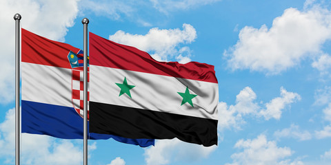 Croatia and Syria flag waving in the wind against white cloudy blue sky together. Diplomacy concept, international relations.