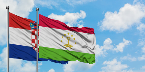 Croatia and Tajikistan flag waving in the wind against white cloudy blue sky together. Diplomacy concept, international relations.