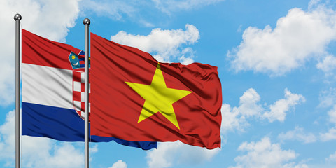 Croatia and Vietnam flag waving in the wind against white cloudy blue sky together. Diplomacy concept, international relations.