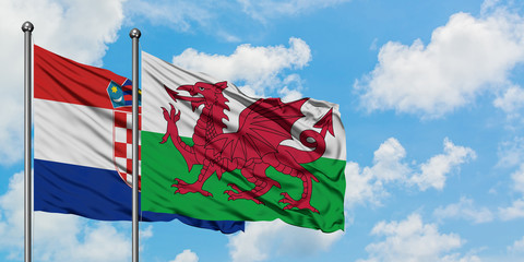 Croatia and Wales flag waving in the wind against white cloudy blue sky together. Diplomacy concept, international relations.