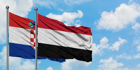 Croatia and Yemen flag waving in the wind against white cloudy blue sky together. Diplomacy concept, international relations.
