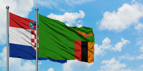 Croatia and Zambia flag waving in the wind against white cloudy blue sky together. Diplomacy concept, international relations.