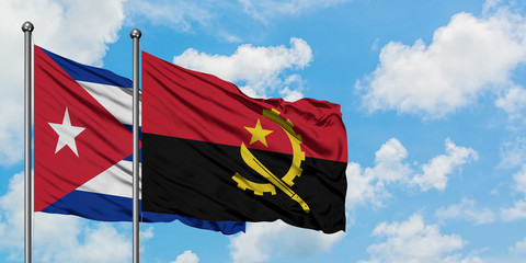 Cuba and Angola flag waving in the wind against white cloudy blue sky together. Diplomacy concept, international relations.