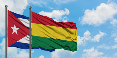 Cuba and Bolivia flag waving in the wind against white cloudy blue sky together. Diplomacy concept, international relations.