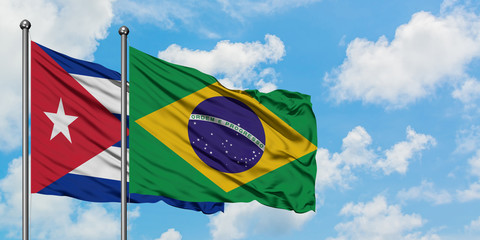 Cuba and Brazil flag waving in the wind against white cloudy blue sky together. Diplomacy concept, international relations.