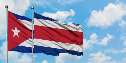 Cuba and Costa Rica flag waving in the wind against white cloudy blue sky together. Diplomacy concept, international relations.
