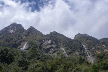 Fototapeta premium view of mountains and three waterfalls