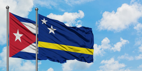 Cuba and Curacao flag waving in the wind against white cloudy blue sky together. Diplomacy concept, international relations.