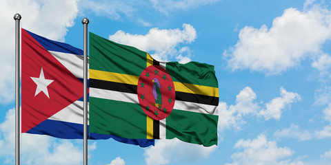 Cuba and Dominica flag waving in the wind against white cloudy blue sky together. Diplomacy concept, international relations.