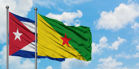 Cuba and French Guiana flag waving in the wind against white cloudy blue sky together. Diplomacy concept, international relations.