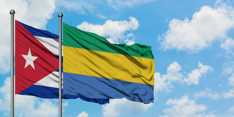 Cuba and Gabon flag waving in the wind against white cloudy blue sky together. Diplomacy concept, international relations.