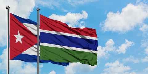 Cuba and Gambia flag waving in the wind against white cloudy blue sky together. Diplomacy concept, international relations.