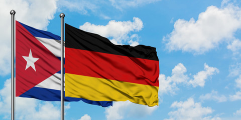 Cuba and Germany flag waving in the wind against white cloudy blue sky together. Diplomacy concept, international relations.