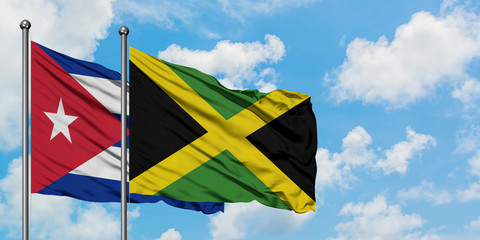 Cuba and Jamaica flag waving in the wind against white cloudy blue sky together. Diplomacy concept, international relations.