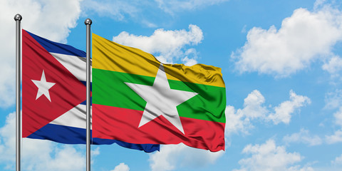 Cuba and Myanmar flag waving in the wind against white cloudy blue sky together. Diplomacy concept, international relations.
