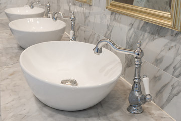 Beautiful vintage faucet with wash basin sink on marble counter bathroom interior retro style