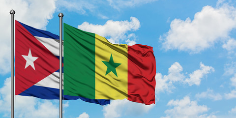 Cuba and Senegal flag waving in the wind against white cloudy blue sky together. Diplomacy concept, international relations.