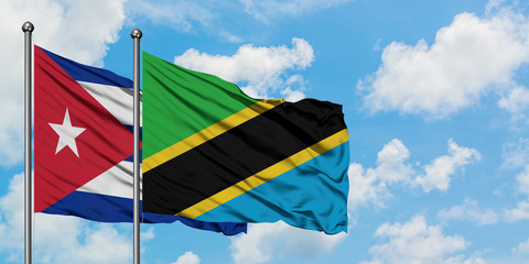 Cuba and Tanzania flag waving in the wind against white cloudy blue sky together. Diplomacy concept, international relations.