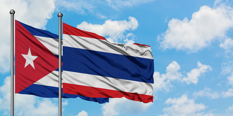 Cuba and Thailand flag waving in the wind against white cloudy blue sky together. Diplomacy concept, international relations.