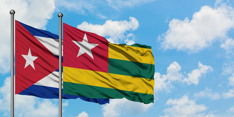 Cuba and Togo flag waving in the wind against white cloudy blue sky together. Diplomacy concept, international relations.
