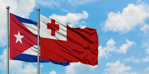 Cuba and Tonga flag waving in the wind against white cloudy blue sky together. Diplomacy concept, international relations.