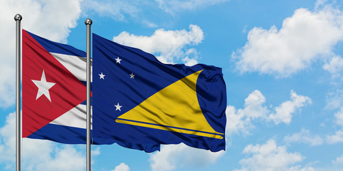 Cuba and Tokelau flag waving in the wind against white cloudy blue sky together. Diplomacy concept, international relations.