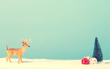 Christmas holiday theme with reindeer and Christmas trees