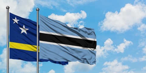 Curacao and Botswana flag waving in the wind against white cloudy blue sky together. Diplomacy concept, international relations.