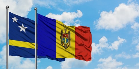 Curacao and Moldova flag waving in the wind against white cloudy blue sky together. Diplomacy concept, international relations.