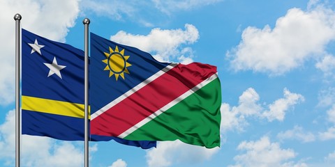 Curacao and Namibia flag waving in the wind against white cloudy blue sky together. Diplomacy concept, international relations.