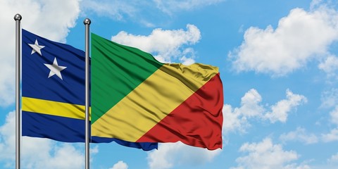Curacao and Republic Of The Congo flag waving in the wind against white cloudy blue sky together. Diplomacy concept, international relations.