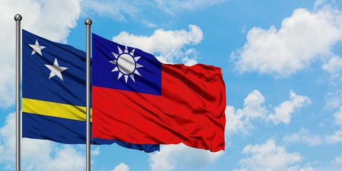 Curacao and Taiwan flag waving in the wind against white cloudy blue sky together. Diplomacy concept, international relations.