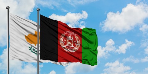 Cyprus and Afghanistan flag waving in the wind against white cloudy blue sky together. Diplomacy concept, international relations.
