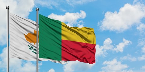 Cyprus and Benin flag waving in the wind against white cloudy blue sky together. Diplomacy concept, international relations.