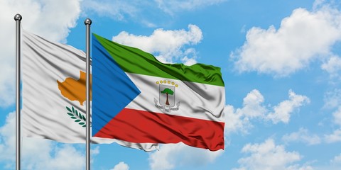 Cyprus and Equatorial Guinea flag waving in the wind against white cloudy blue sky together. Diplomacy concept, international relations.