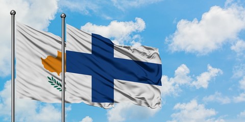 Cyprus and Finland flag waving in the wind against white cloudy blue sky together. Diplomacy...