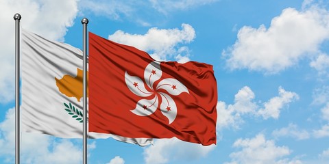 Cyprus and Hong Kong flag waving in the wind against white cloudy blue sky together. Diplomacy concept, international relations.