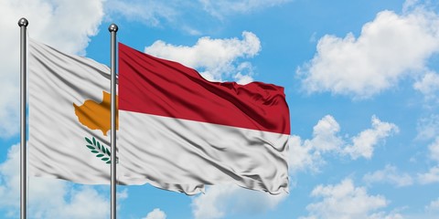 Cyprus and Indonesia flag waving in the wind against white cloudy blue sky together. Diplomacy concept, international relations.