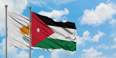 Cyprus and Jordan flag waving in the wind against white cloudy blue sky together. Diplomacy concept, international relations.