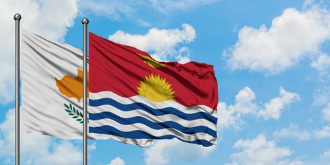 Cyprus and Kiribati flag waving in the wind against white cloudy blue sky together. Diplomacy concept, international relations.