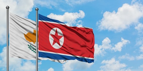 Cyprus and North Korea flag waving in the wind against white cloudy blue sky together. Diplomacy concept, international relations.