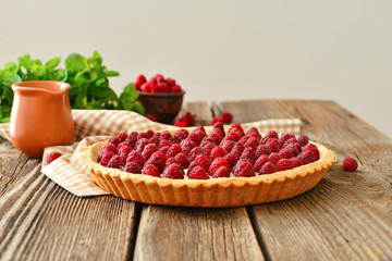 Sweet raspberry cake on wooden table